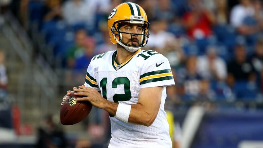 FOXBORO, MA - AUGUST 13: Aaron Rodgers #12 of the Green Bay Packers drops back to pass in the first quarter against the New England Patriots during a preseason game at Gillette Stadium on August 13, 2015 in Foxboro, Massachusetts.