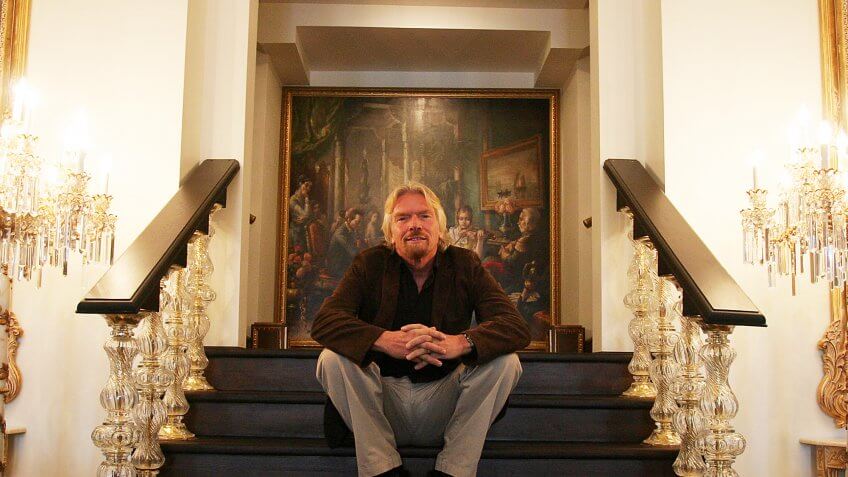 Richard Branson sitting on stairs