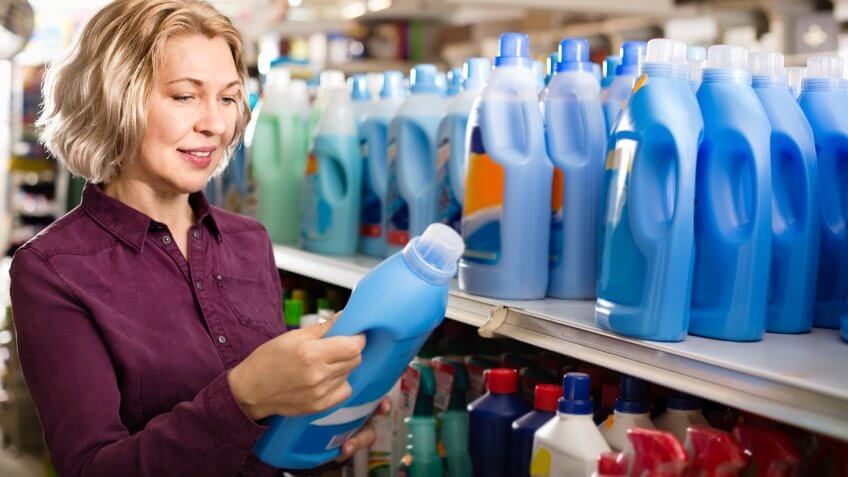 Woman selecting fabric conditioner in store