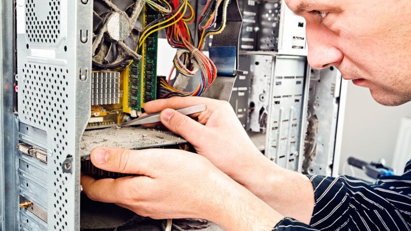 man working on inside of computer tower man working on inside of computer tower