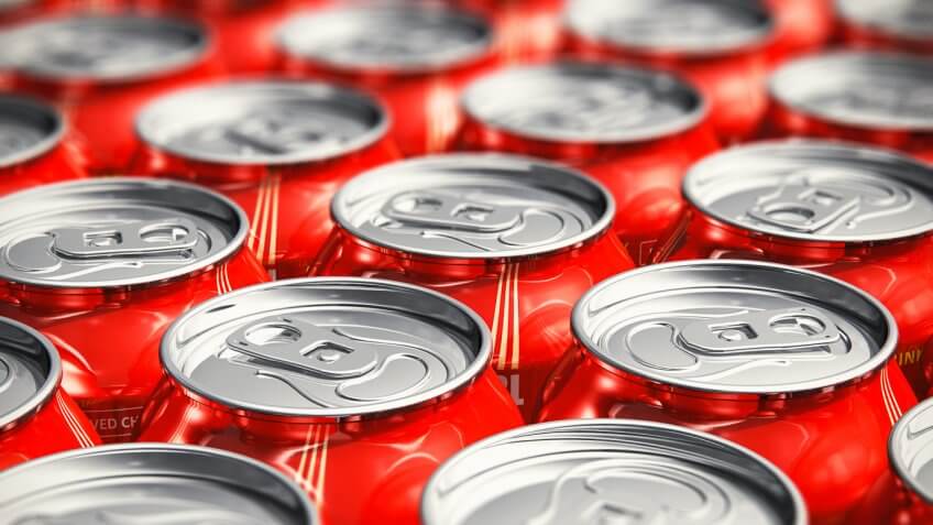 cans of coca cola lined up neatly in rows