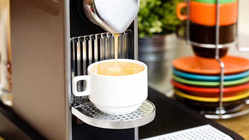 Espresso machine pouring coffee into a coffee cup