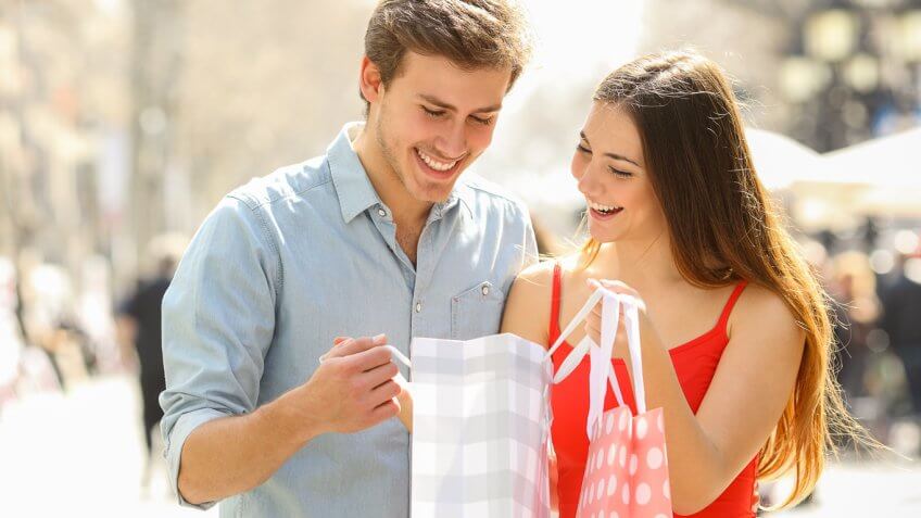 Couple shopping and looking into shopping bag Couple shopping and looking into shopping bag