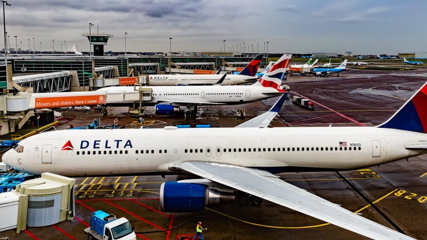 Fleet of Delta airplanes parked at different terminals Fleet of Delta airplanes parked at different terminals