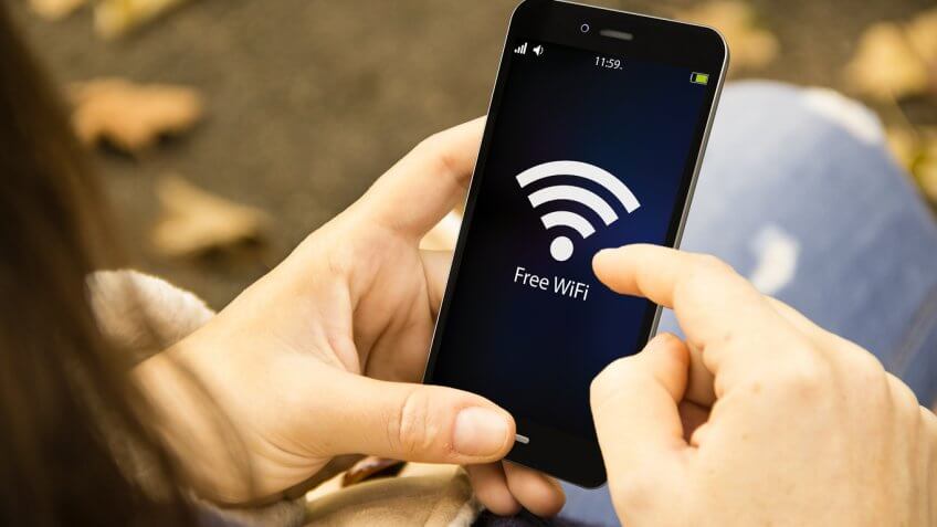 Person connecting to WiFi on their phone Person connecting to WiFi on their phone