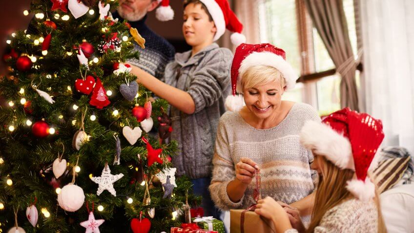 family celebrating christmas around christmas tree family celebrating christmas around christmas tree