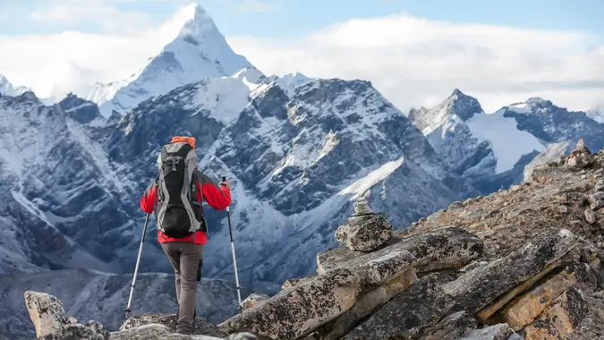 Hiker walks on train in Himalayas.