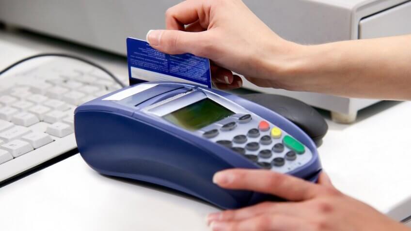 hand swiping credit card payment