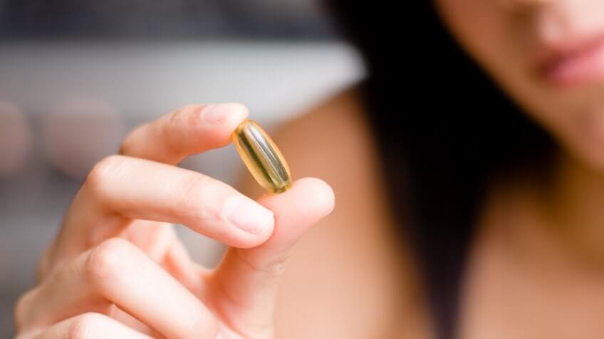 woman holding liquid-filled capsule
