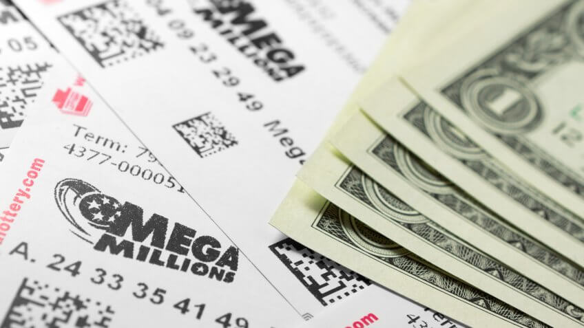 Philadelphia, United States - March 13, 2011: Many Mega Millions lottery tickets and one dollar bills.