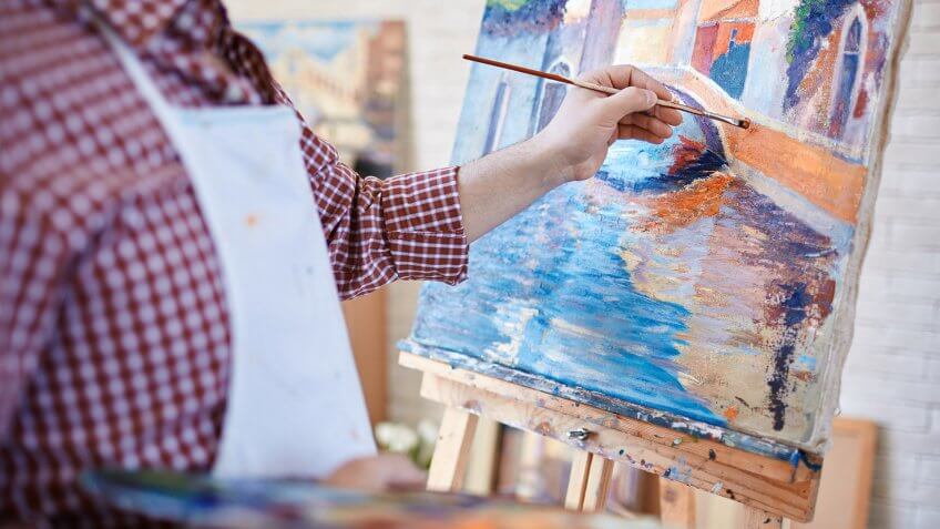 man painting on a canvas