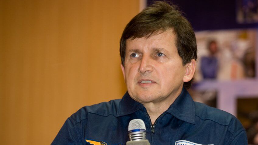 Spaceflight Participant Charles Simonyi answers questions from behind glass during a press conference on Wednesday, March 25, 2009 at the Cosmonaut Hotel in Baikonur, Kazakhstan.
