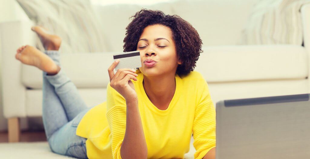 Earn bonuses. woman blowing kiss at credit card