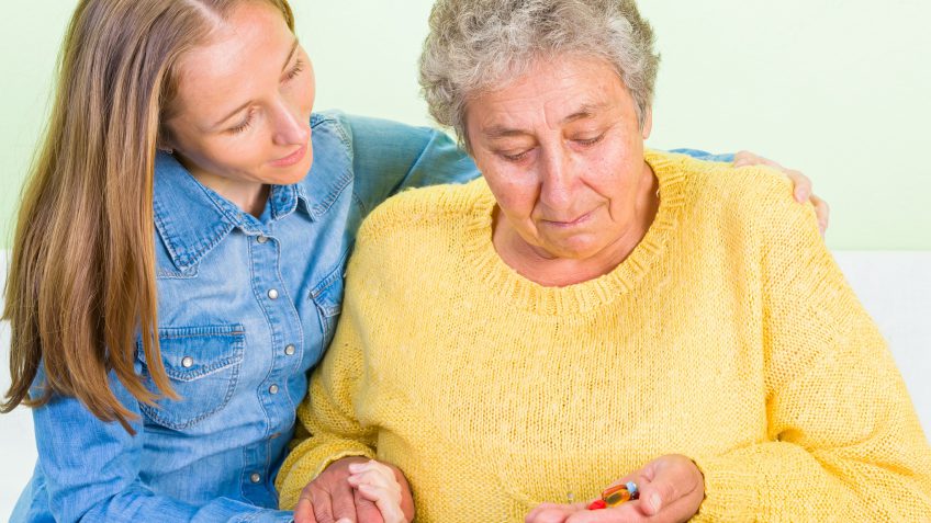 young woman attending to a dementia patient