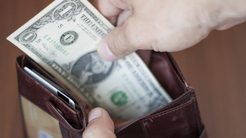man pulling $1 bill cash money out of his wallet
