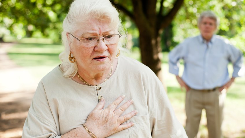 A senior woman experiencing chest pain.