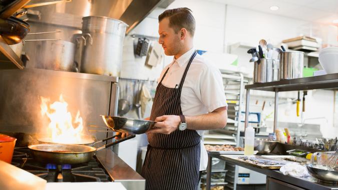 10 Best and Worst Industries for Work-Life Balance, 30-34 years, 30-34 years, apron, blurred motion, candid, caucasian, chef, col, Alberta, Apron, Calgary, Canada, Candid, Caucasian, Chef, Cooking, Expertise, Heat, Motion, Occupation, One Person, Real People, Restaurant, Skill, Stubble, Wearing, Working, blurred motion, color image, commercial kitchen, copy space, flame, flaming, food and drink, food and drink industry, gourmet, holding, horizontal, hot, indoors, looking down, man, mid adult, mid adult men, pan, people, photography, preparation, side view, standing, stove, three quarter length, tilt