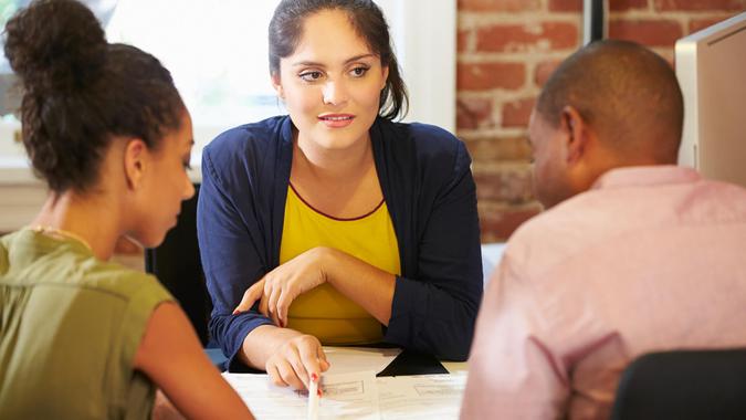 Focus on Your Long-Term Goals Couple Meeting With Financial Advisor In Office.