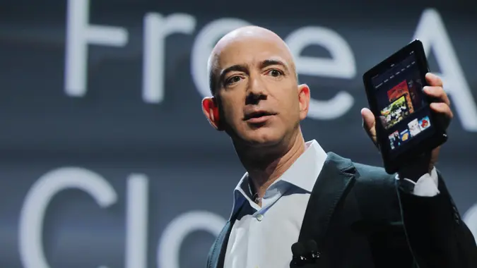 NEW YORK, NY - SEPTEMBER 28: Amazon founder Jeff Bezos holds the new Amazon tablet called the Kindle Fire on September 28, 2011 in New York City.