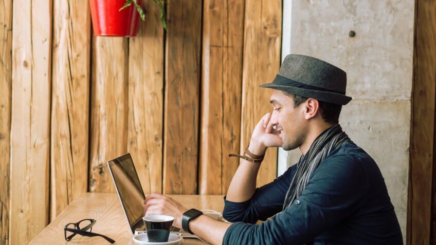 man at coffee shop with laptop