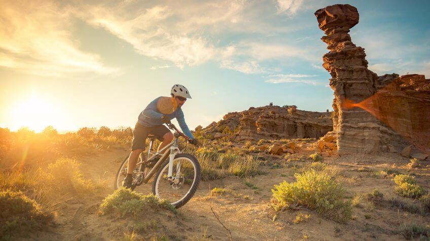 a man pedals his mountain bike while cycling in solitude.