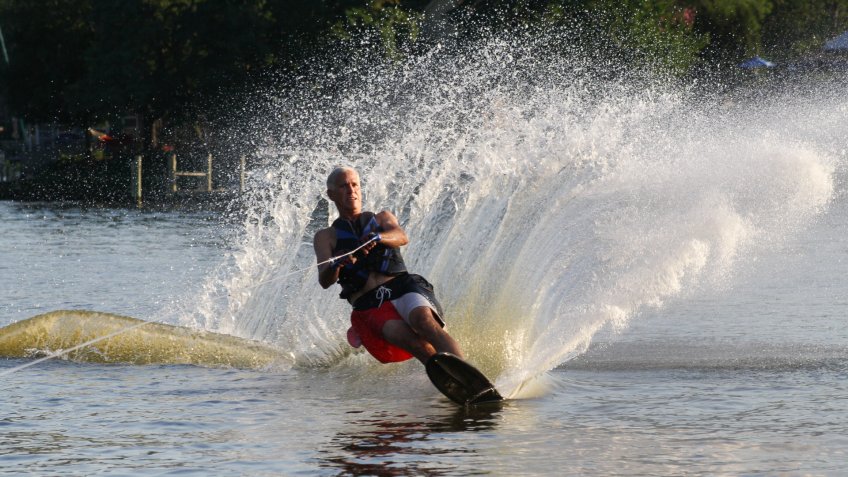 Annapolis, Maryland, USA- July 26, 2010: Mature Man Slalom Water Skiing on a tributary of the Chesapeake Bay in Annapolis, Maryland, USA.