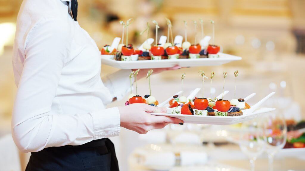 Get a Temporary or Seasonal Job waitress holding two plates of appetizers