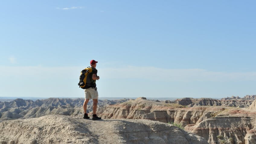 Man hiking in Badlands National Park, South Dakota, USA.