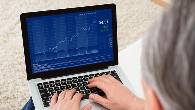 Stick With Your Investment Strategy mature man looking at stock charts