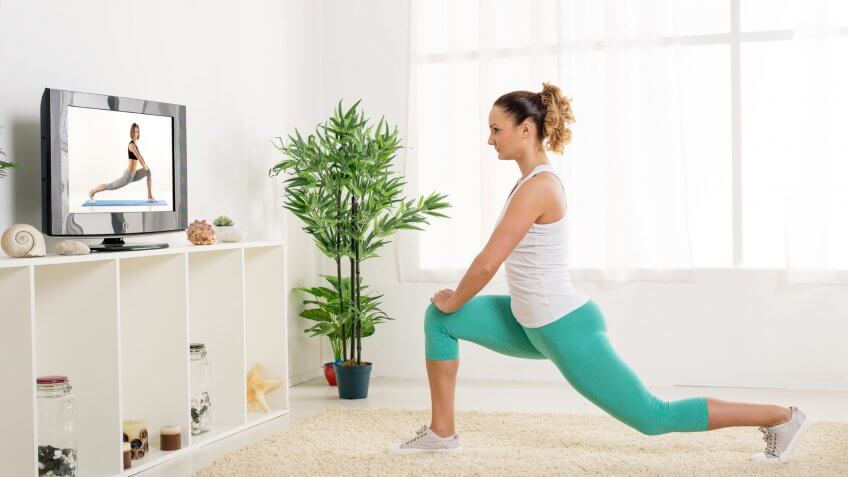 girl practicing yoga in house