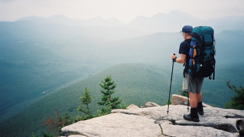 A backpacker views mountains to be travelled in New Hampshire on his 3500 km.
