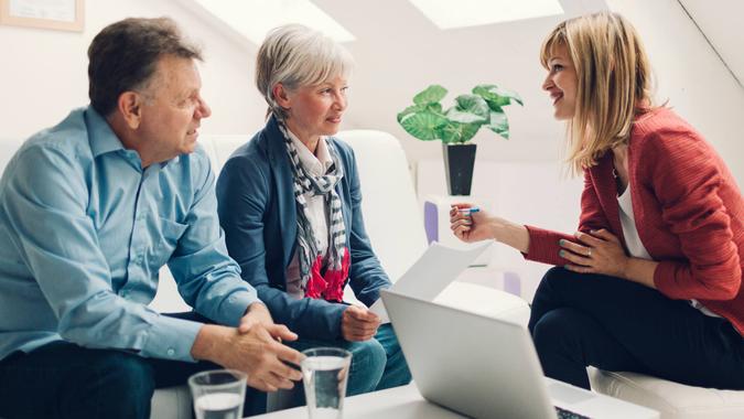 Meet With a Financial Planner or Advisor Couple Meeting with Financial Advisor.