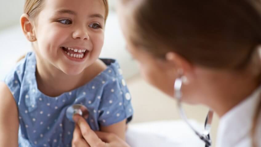 doctor checking a child's heartbeat