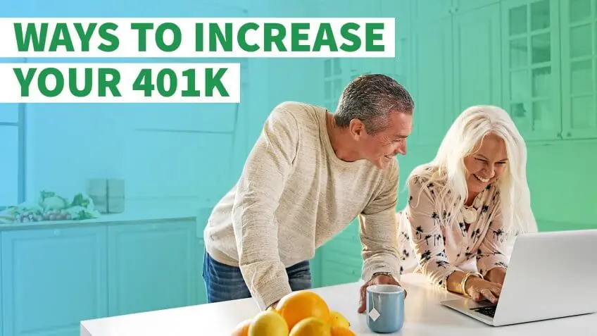 happy middle aged couple using laptop on kitchen counter