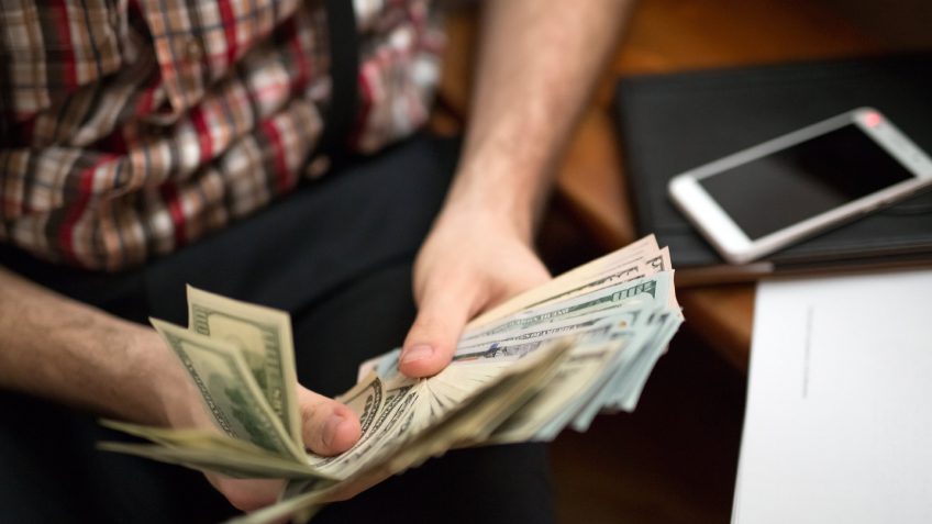man fanning out money