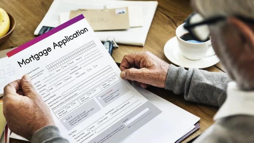 close up of man holding mortgage application