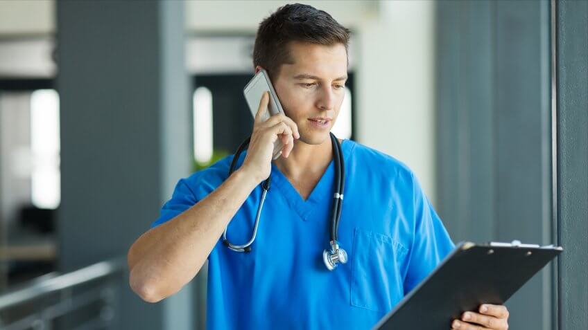 professional medical doctor talking on mobile phone in hospital.