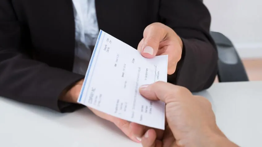close up of person receiving a check