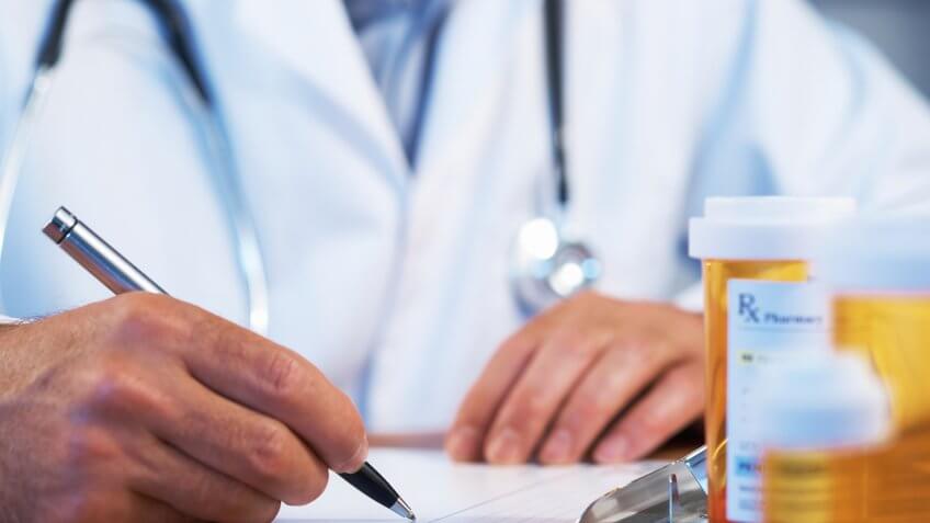 doctor filling out a prescription