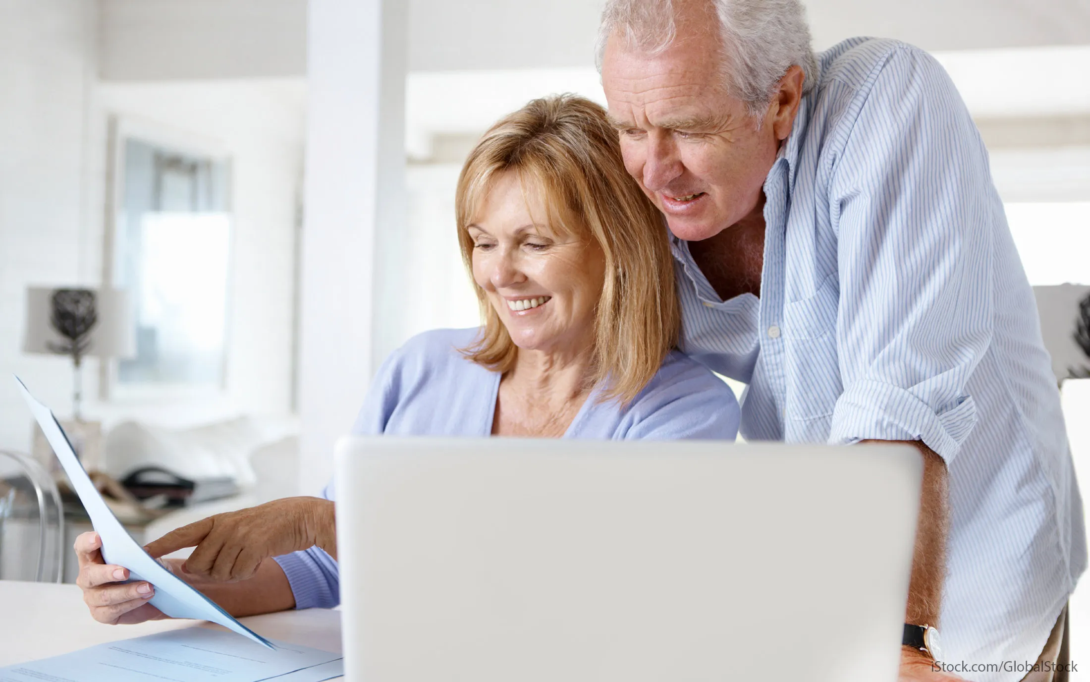 older couple managing retirement contributions