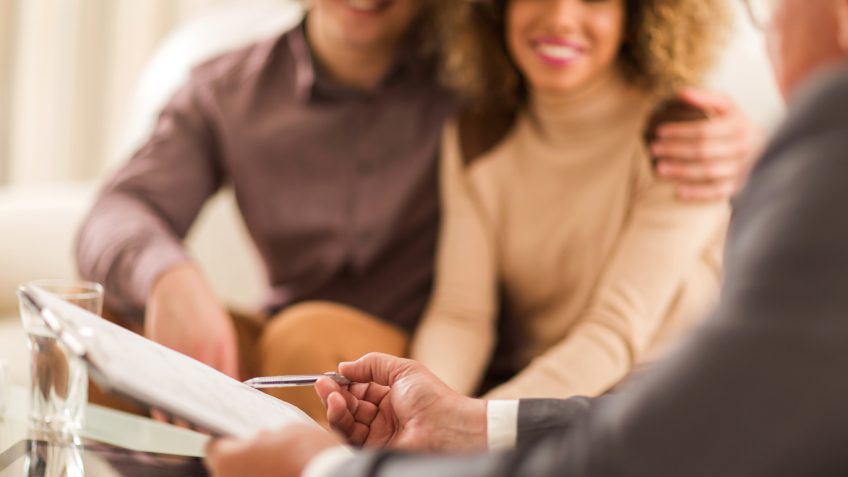 young couple consulting a financial professional