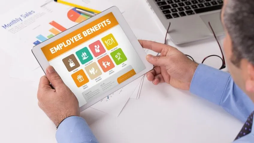 man looking at employee benefits screensaver on smart device