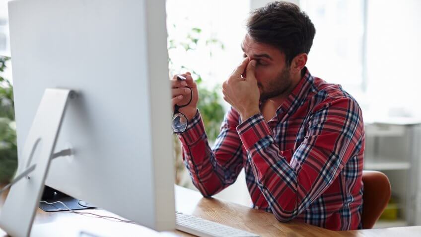 Shot of an overworked young designer looking exhausted