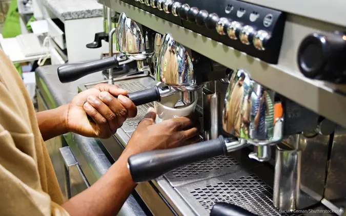 Person using espresso machine