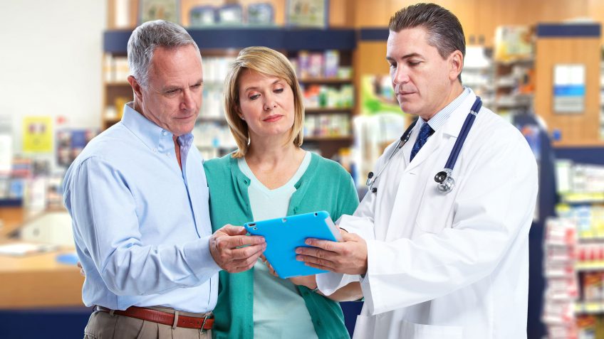 couple speaking to a pharmacist