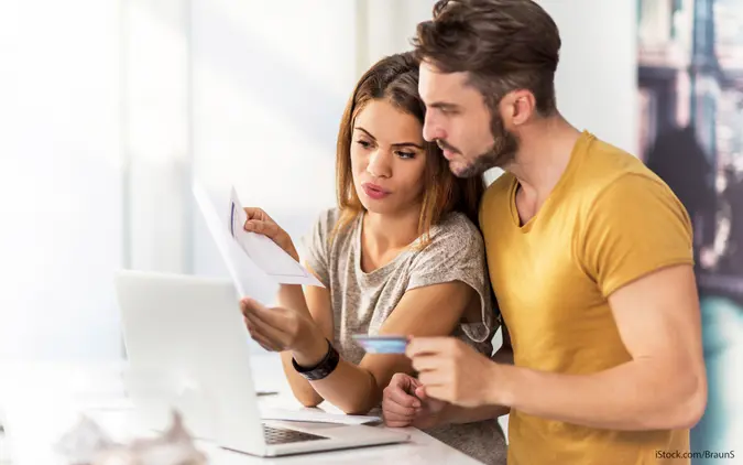 a couple reviews their financial paperwork