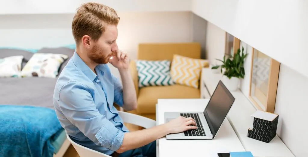 man at desk on laptop