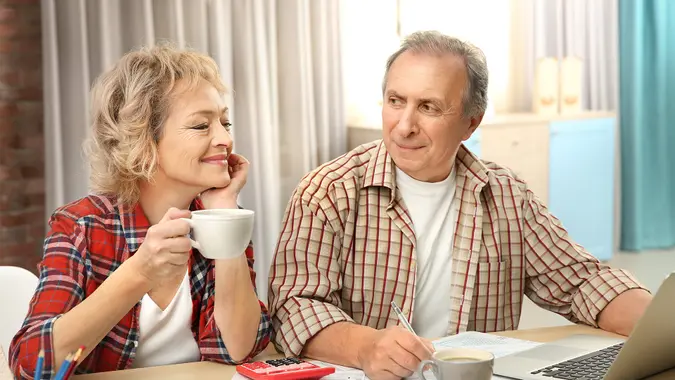 middle aged couple discussing paperwork