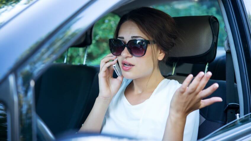 woman on her phone in the car