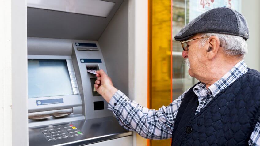 senior man at ATM senior man at ATM